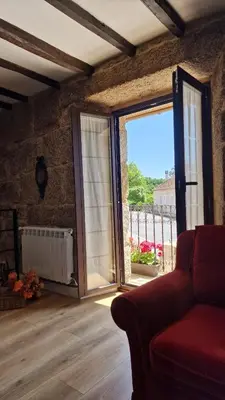 a living room with a large sliding glass door at Casa da Penela in Nogueira de Ramuin