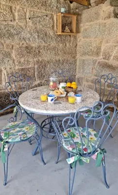 a table and two chairs with food on it at Casa da Penela in Nogueira de Ramuin