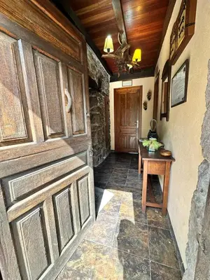 a room with a wooden door and a table at CASA CHANOS in Cangas del Narcea