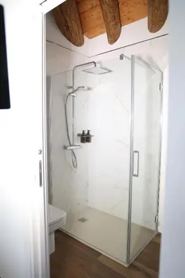a shower with a glass door in a bathroom at Casa Os Prados da Albela in Tríacastela
