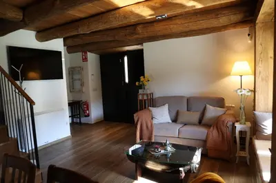a living room with a couch and a table at Casa Os Prados da Albela in Tríacastela
