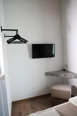 a bedroom with a tv on the wall and a bed at Casa Os Prados da Albela in Tríacastela