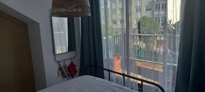 a bedroom with a bed and a large window at ÁTICO 2 terrazas LEMASALUD in Ares