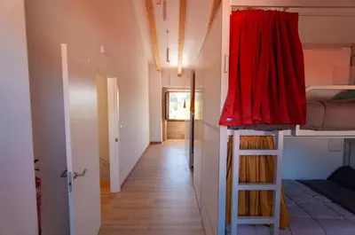 a hallway with a room with a bed and a ladder at A Casa Do Boi in Amés