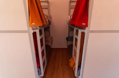 a closet with two shelves with colorful clothes at A Casa Do Boi in Amés