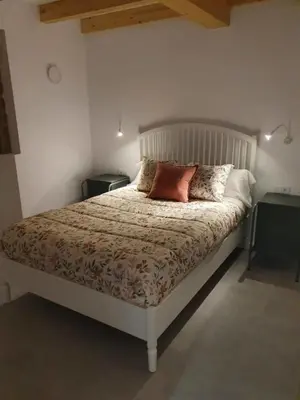 a bed with two pillows on it in a bedroom at A Casa Do Boi in Amés