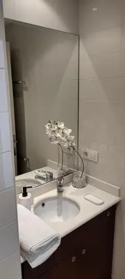 a bathroom with a sink and a mirror and towels at Hospedería San Froilan in Lugo