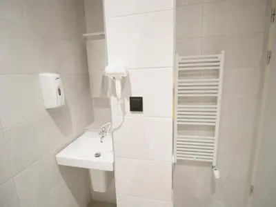 a white bathroom with a sink and a toilet at CASA MIRADOR REZA Alojamiento Termas in Ourense