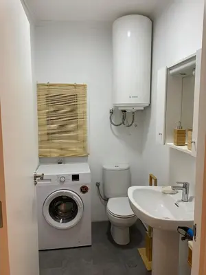 a bathroom with a washing machine and a sink at N&E - Home Celanova AVD San Rosendo in Celanova