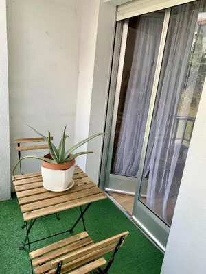 a potted plant sitting on a bench on a balcony at N&E - Home Celanova AVD San Rosendo in Celanova