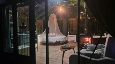 a room with a bed and a room with a fireplace at REMANSO DE TRASFONTAO_Nido 360° in Silleda