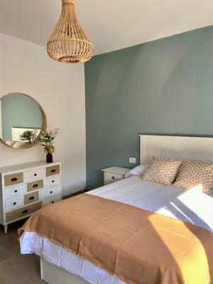 a bedroom with a bed and a mirror at Casa Bimba in Sober