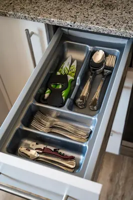 a drawer in a kitchen sink with utensils at Casa Bimba in Sober
