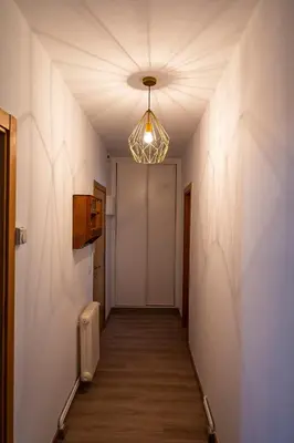 a hallway with a light fixture and a door at Casa Bimba in Sober