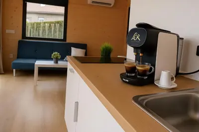 a coffee maker sitting on a counter next to a sink at Cabañas Compostela - Cabaña A Fervenza in Santiago de Compostela