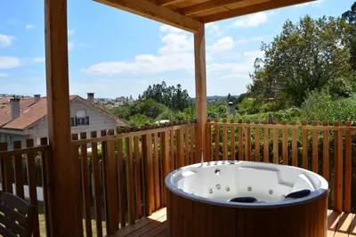 a hot tub on the deck of a house at Cabañas Compostela - Cabaña La Catedral con bañera de hidromasaje in Santiago de Compostela