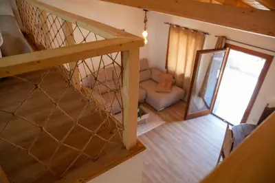 an overhead view of a room with a staircase and a mirror at A casa do Xastre in Allariz