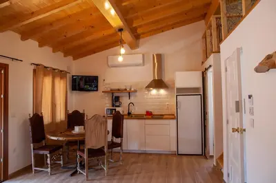 a kitchen and dining room with a table in a room at A casa do Xastre in Allariz