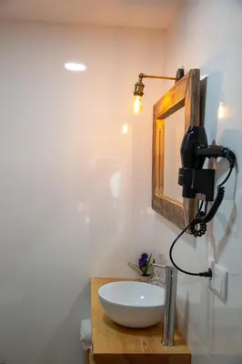 a bathroom with a white sink and a mirror at A casa do Xastre in Allariz
