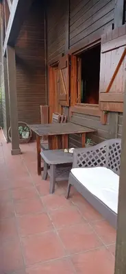 a patio with a table and benches on a patio at Acogedora cabaña con piscina in Pontevedra