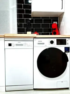 a white washer and dryer in a kitchen at Apartamento Puente Romano in Ourense