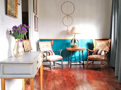 a room with chairs and a table with a vase of flowers at Casa San Pablo in Melide
