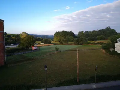 a large grassy field with a tennis court at Casa San Pablo in Melide