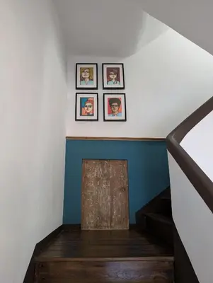 a stairway with three framed pictures on the wall at Casa San Pablo in Melide