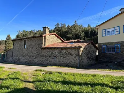 a brick house with a chimney on a street at Casal de Pedra in Santa Irene