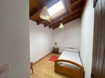 a bedroom with a bed and a window at Casal de Pedra in Santa Irene