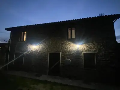 a stone house at night with lights on it at Casal de Pedra in Santa Irene