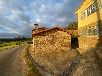 a brick building on the side of a road at Casal de Pedra in Santa Irene