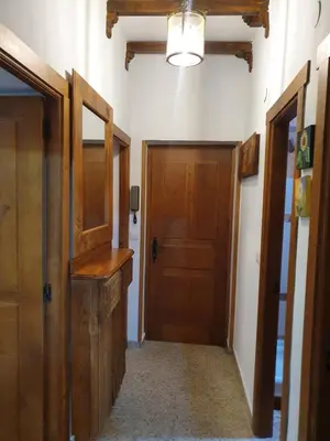 a hallway with a wooden door and a hallway with a hallway at Casa Celedonio in Cerredo