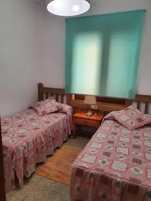 a room with two beds and a large screen at Casa Celedonio in Cerredo