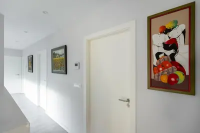 a bedroom with a large bed and white cabinets at Villa con piscina y jardín, Santiago de Compostela in Teo