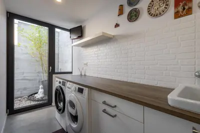 a walk in closet with wooden cabinets and blue towels at Villa con piscina y jardín, Santiago de Compostela in Teo