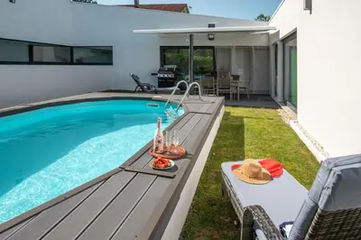 a entrance to a house with a garage at Villa con piscina y jardín, Santiago de Compostela in Teo