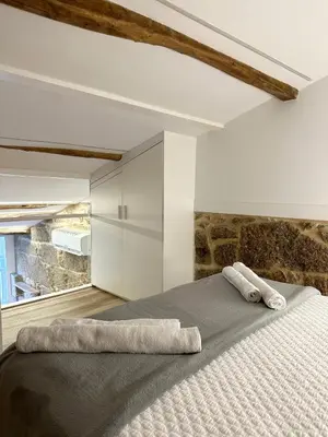 a bedroom with a large bed with two towels on it at Celanova House in Celanova
