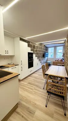 a kitchen and dining room with a table and chairs at Celanova House in Celanova