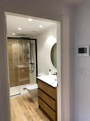 a bathroom with a toilet and a sink and a shower at Celanova House in Celanova