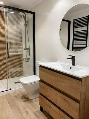 a bathroom with a sink and a toilet and a mirror at Celanova House in Celanova