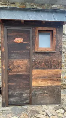 a wooden garage door with a sign on it at Casa Gelito in Espinareda de Vega