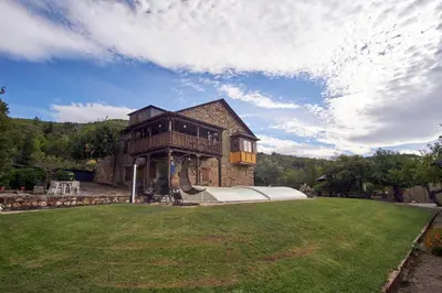 a large house with a large yard with a building at Casa Gelito in Espinareda de Vega