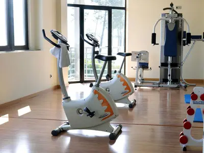 two exercise bikes in a room with a gym at Exe Auriense in Ourense