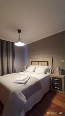 a bedroom with a bed with two towels on it at Duplex acogedor CAMINO INGLÉS a 10 min de Santiago in Sigüeiro