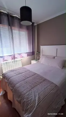 a small bedroom with a bed and a dresser at Duplex acogedor CAMINO INGLÉS a 10 min de Santiago in Sigüeiro
