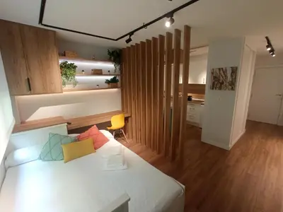 a bedroom with a white bed with colorful pillows on it at Precioso loft a 600m de la catedral in Santiago de Compostela