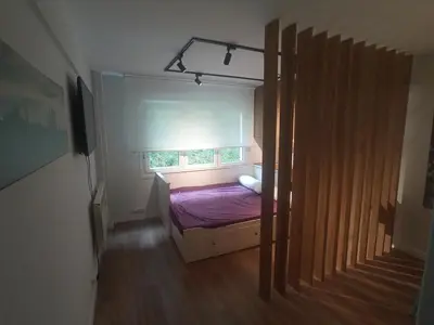a small bedroom with a bed and a window at Precioso loft a 600m de la catedral in Santiago de Compostela