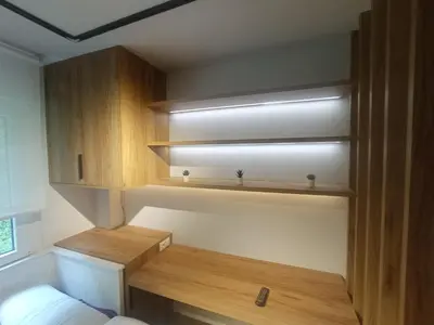 a small room with wooden shelves and a bed at Precioso loft a 600m de la catedral in Santiago de Compostela
