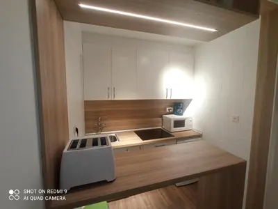 a small kitchen with a sink and a microwave at Precioso loft a 600m de la catedral in Santiago de Compostela